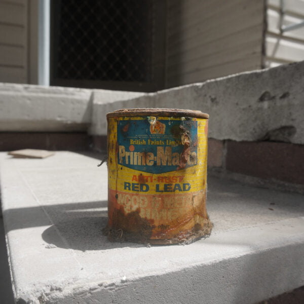 Liverpool, NSW 2170 11 A worn and rusty can of paint labeled "Prime Mat" sits on a concrete step in bright sunlight, remnants from an old home demolition project.